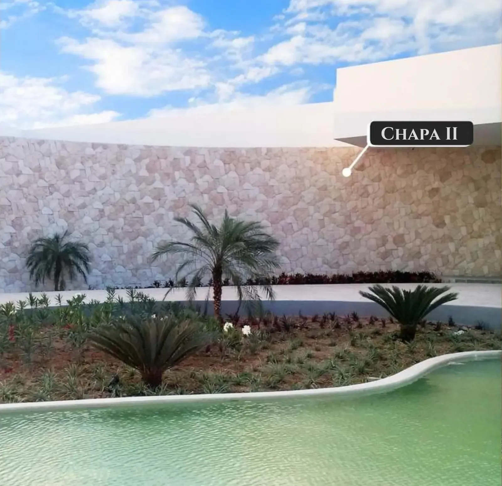 Stone-clad pool surround and water feature at a South Florida property